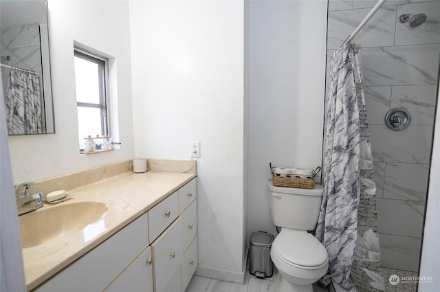 bathroom featuring curtained shower, vanity, and toilet