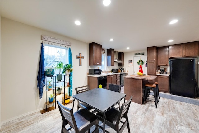 dining space with light hardwood / wood-style flooring