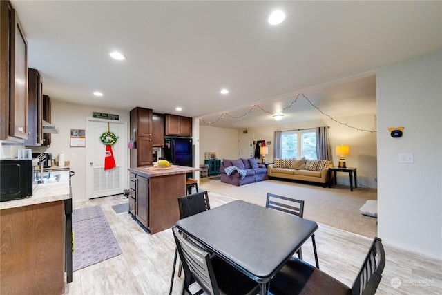 dining space featuring light wood-type flooring