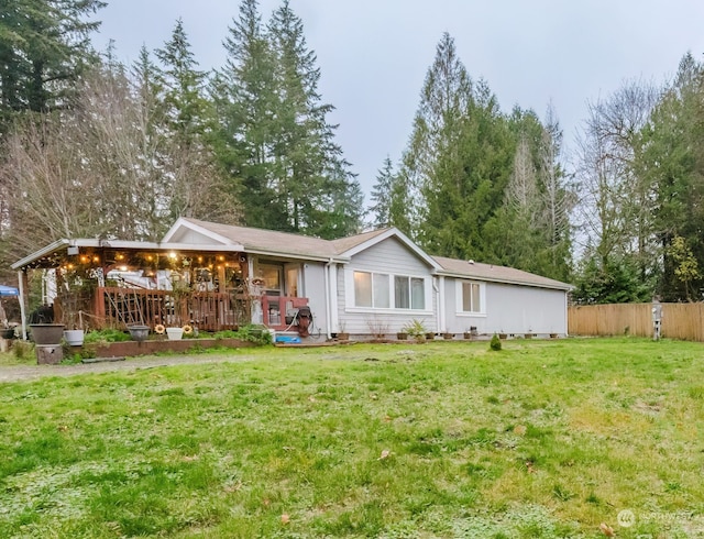 rear view of property with a lawn