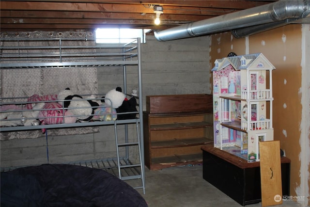 bedroom featuring concrete flooring