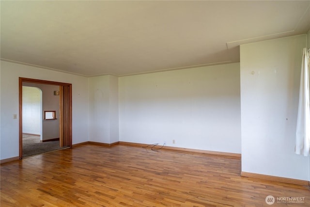 spare room with light wood finished floors and baseboards