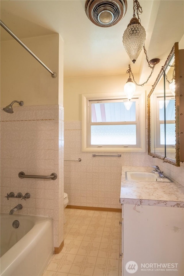 bathroom featuring visible vents, a wealth of natural light, vanity, and toilet
