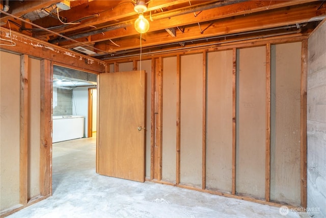 unfinished below grade area featuring washer / dryer