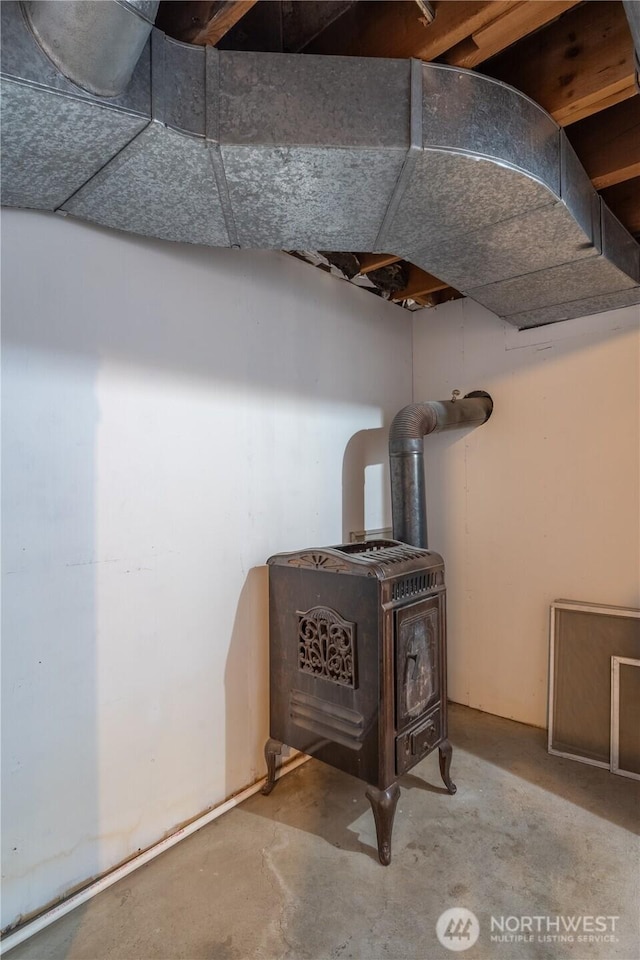 details featuring concrete floors and a wood stove