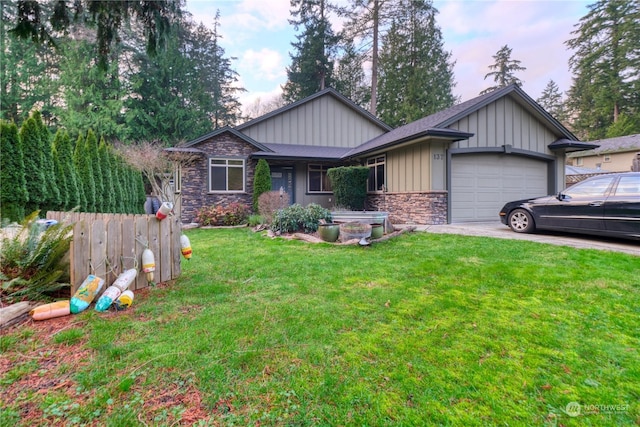 view of front of property featuring a yard and a garage