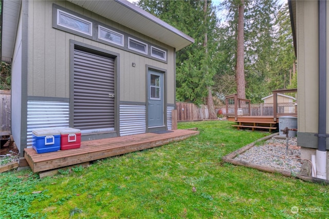 view of yard featuring a deck and an outdoor structure