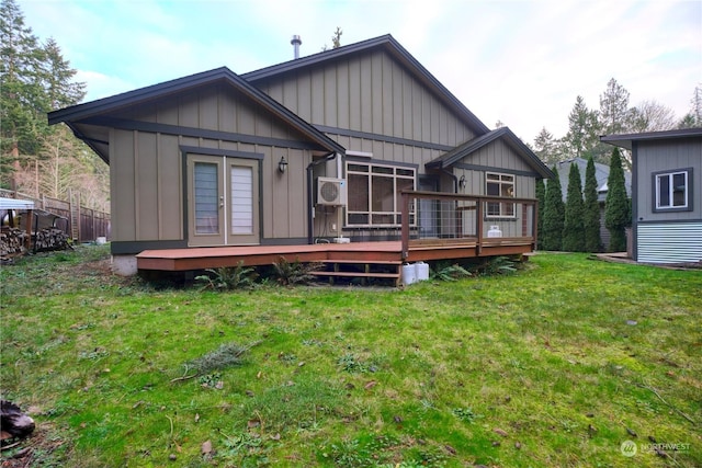 rear view of house with a lawn, a deck, and french doors