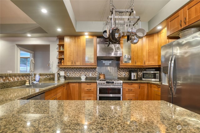 kitchen featuring backsplash, dark stone counters, sink, ornamental molding, and stainless steel appliances