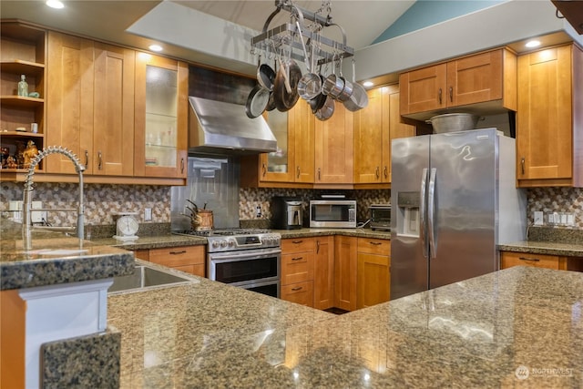 kitchen with tasteful backsplash, dark stone countertops, stainless steel appliances, and vaulted ceiling