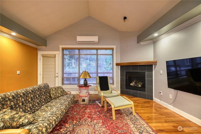 living room with a tile fireplace, hardwood / wood-style flooring, a wall mounted AC, and lofted ceiling