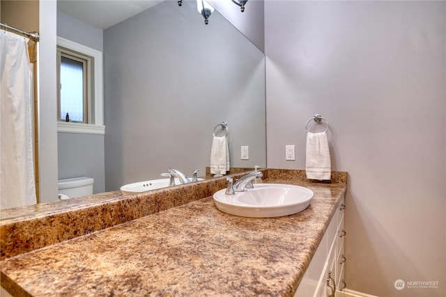 bathroom featuring vanity and toilet