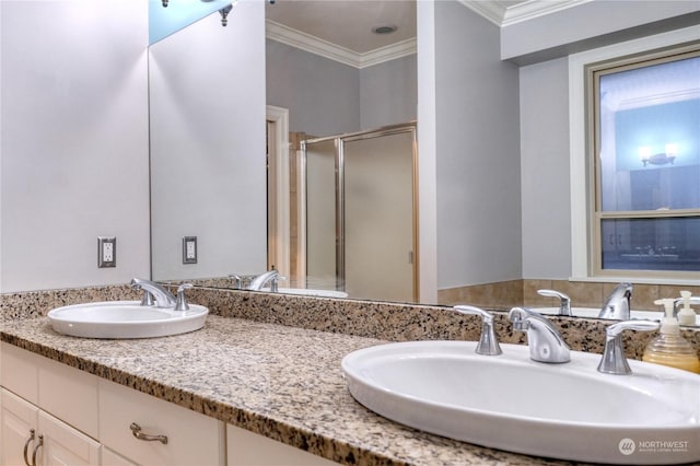 bathroom with crown molding, a shower with door, and vanity