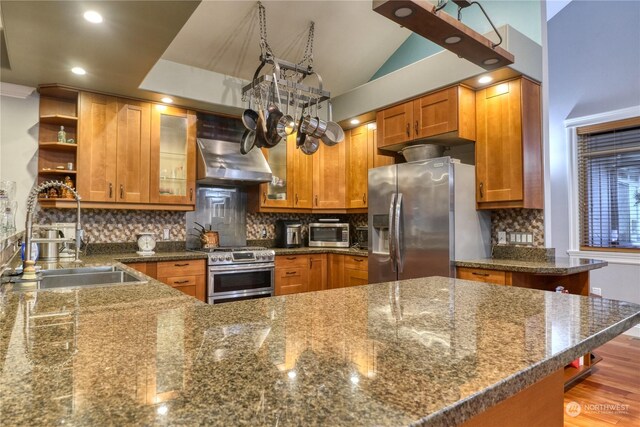 kitchen with hardwood / wood-style floors, stainless steel appliances, tasteful backsplash, and sink