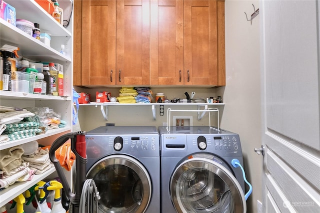 clothes washing area featuring cabinets and independent washer and dryer