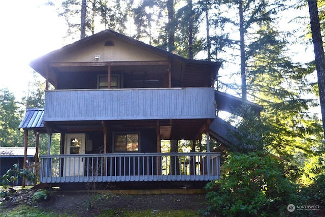 back of house featuring a balcony