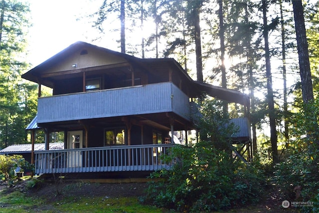 back of house featuring a balcony