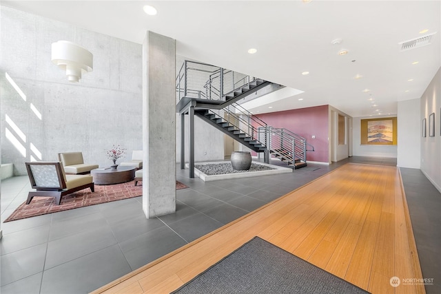 lobby with visible vents and stairs