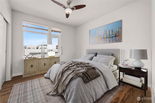 bedroom featuring ceiling fan, dark wood-type flooring, and a closet