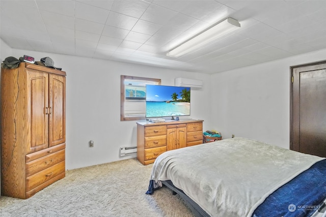 carpeted bedroom featuring an AC wall unit and a baseboard heating unit