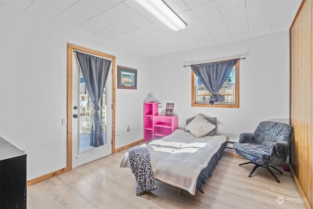 bedroom featuring light hardwood / wood-style floors and access to exterior