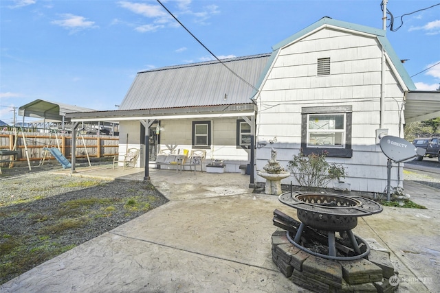 back of property with a carport