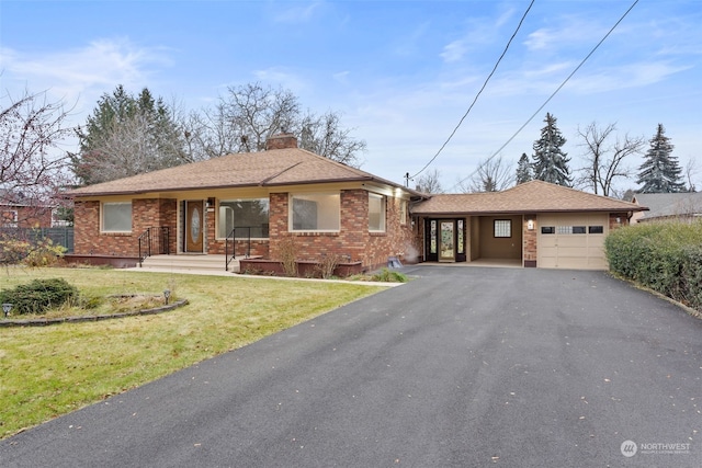 view of front of property with a front yard and a garage