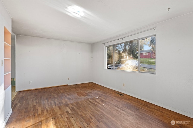 empty room featuring wood-type flooring