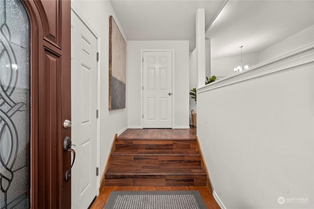 interior space with dark hardwood / wood-style flooring and a chandelier