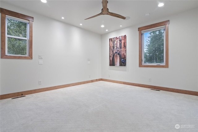 spare room featuring ceiling fan and carpet floors