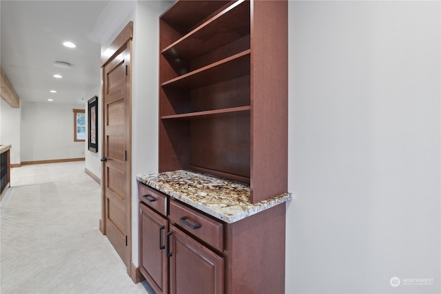 interior space with light carpet and light stone counters