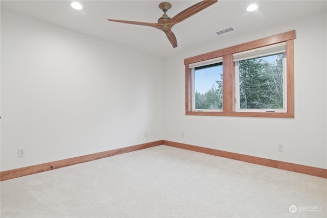 carpeted empty room featuring ceiling fan