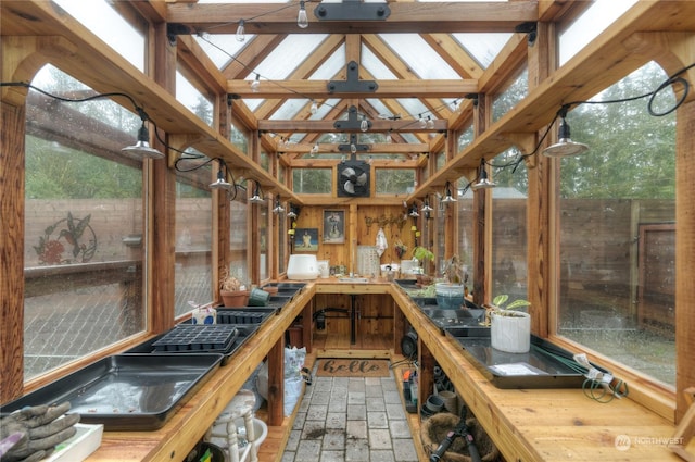 unfurnished sunroom with lofted ceiling and plenty of natural light