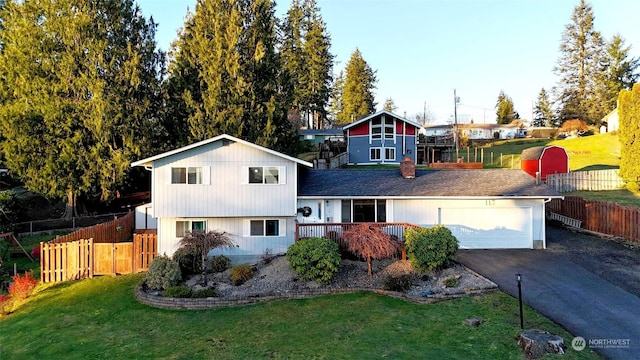 view of front of home with a garage and a front lawn