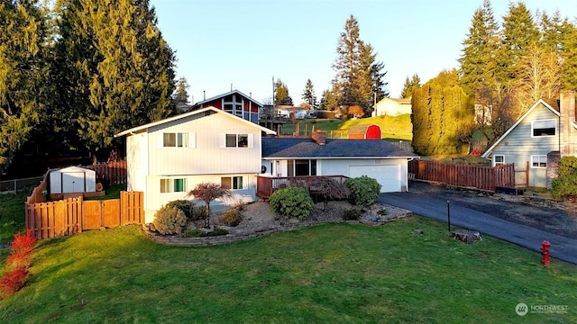 view of front of house with a garage and a front lawn