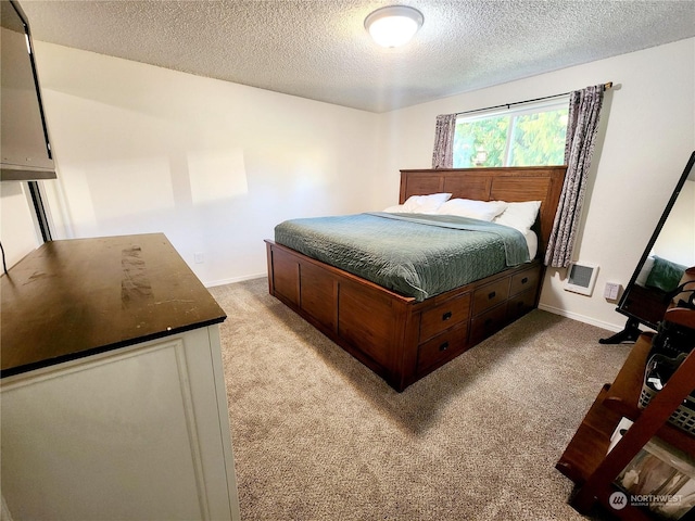 carpeted bedroom featuring a textured ceiling