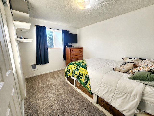 carpeted bedroom with a textured ceiling