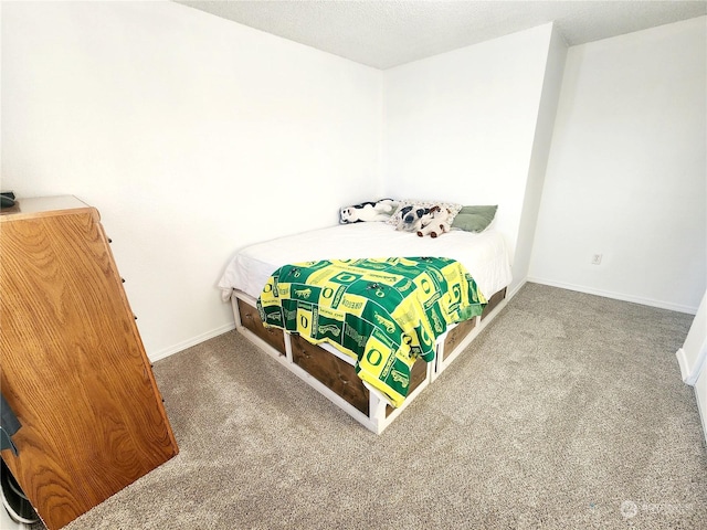 bedroom featuring carpet flooring and a textured ceiling