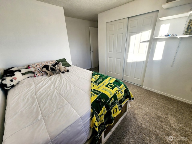 bedroom with a closet, carpet floors, and a textured ceiling