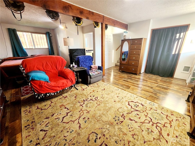 living room with a textured ceiling and hardwood / wood-style flooring