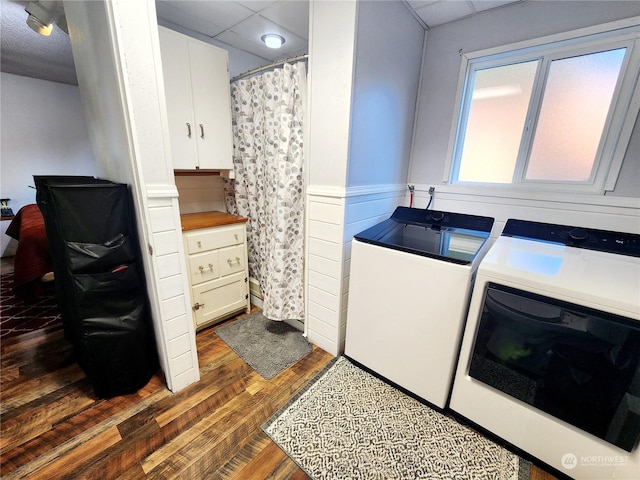 washroom featuring washer and clothes dryer and dark hardwood / wood-style floors