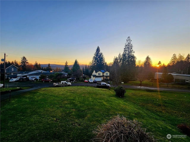 view of yard at dusk