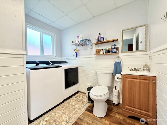 117 Heritage Dr, Elma, WA 98541 - bathroom with vanity, toilet, wood finished floors, wainscoting, and washer and clothes dryer