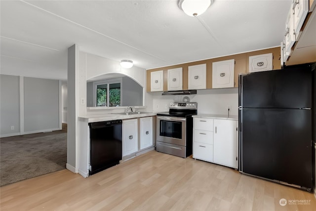 kitchen with black appliances, sink, light wood-type flooring, range hood, and white cabinetry