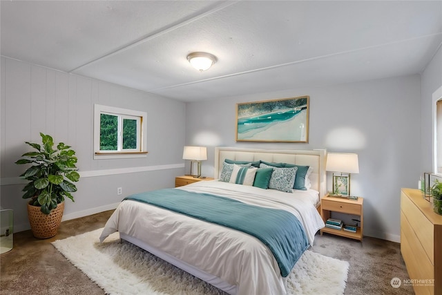 bedroom featuring dark carpet