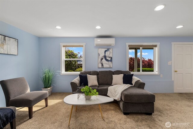 living area with an AC wall unit, recessed lighting, and carpet