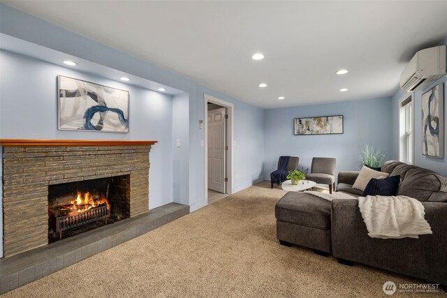 living area featuring an AC wall unit, recessed lighting, carpet floors, and a warm lit fireplace