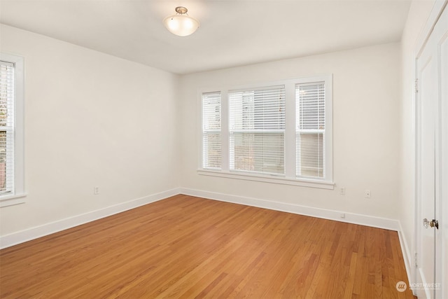 empty room with hardwood / wood-style flooring