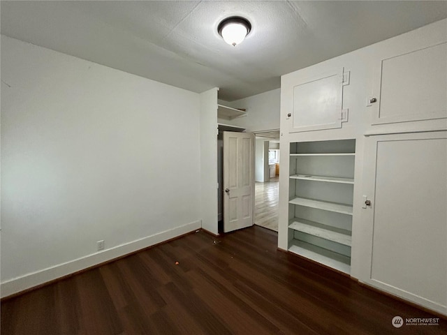 unfurnished bedroom featuring dark hardwood / wood-style floors