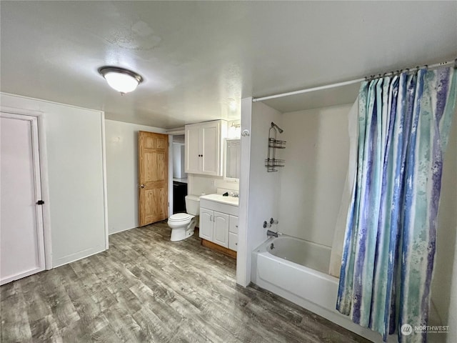 full bathroom featuring vanity, hardwood / wood-style flooring, toilet, and shower / bathtub combination with curtain